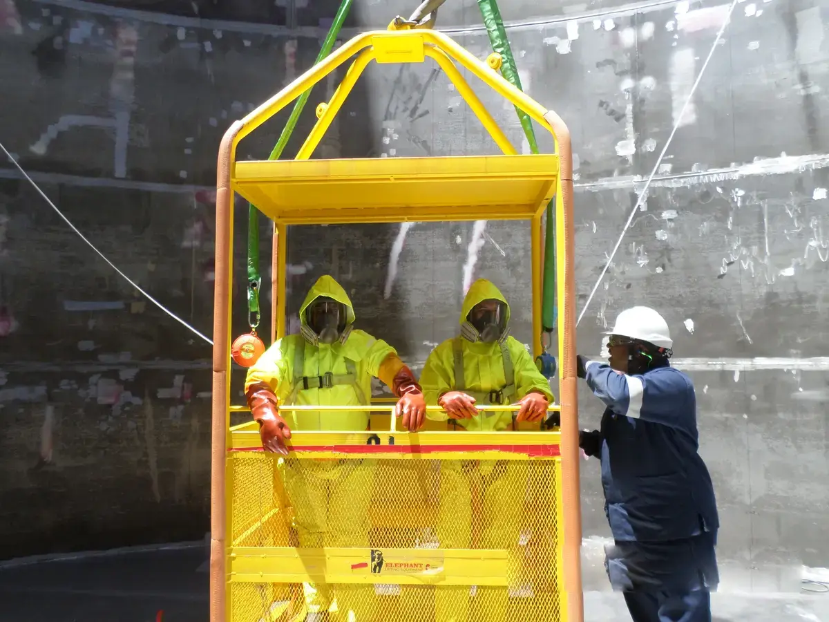 Man cage inspection inside PTR tank during construction at Koeberg