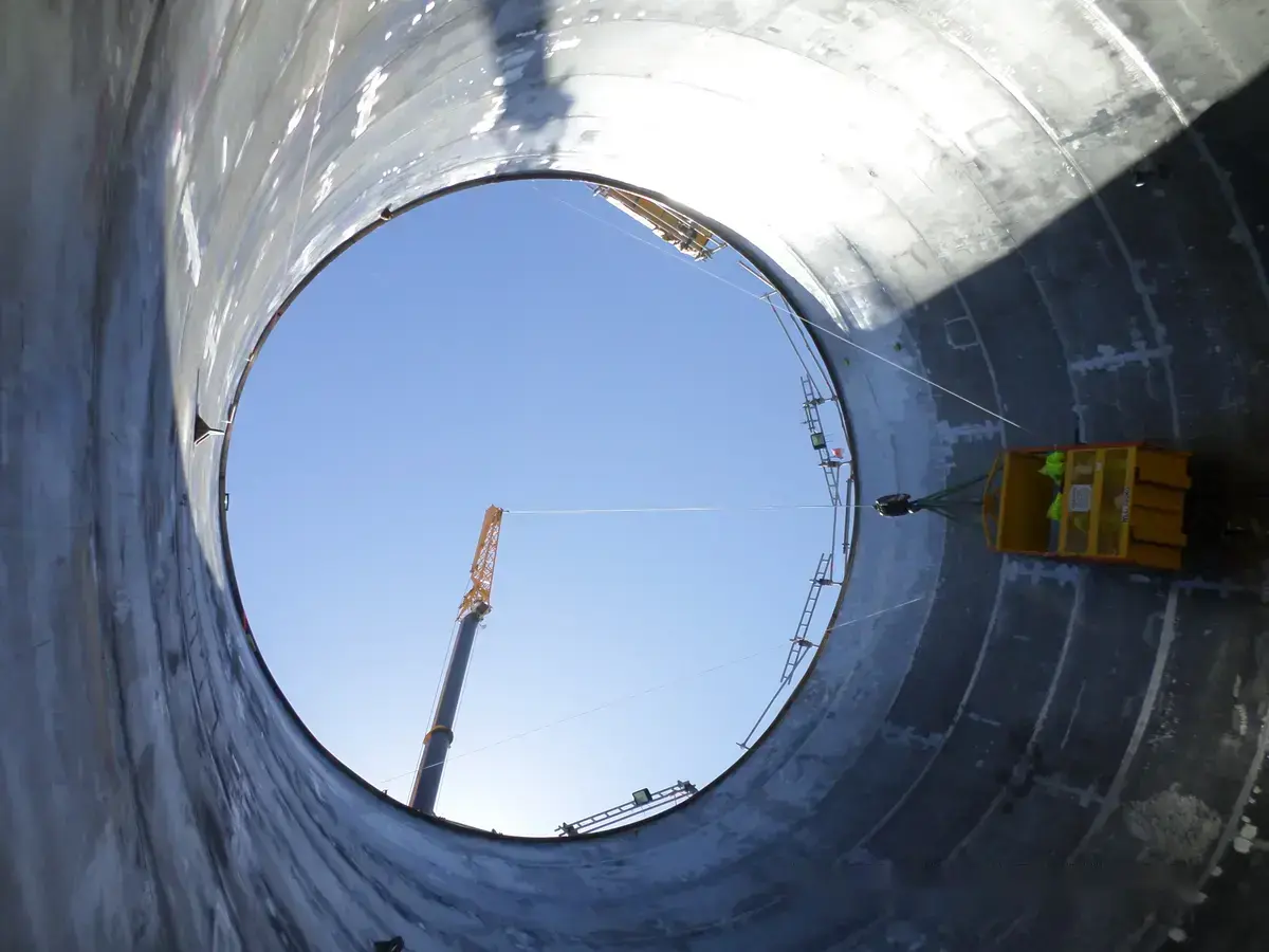Overhead view of PTR tank interior with man cage during weld inspection